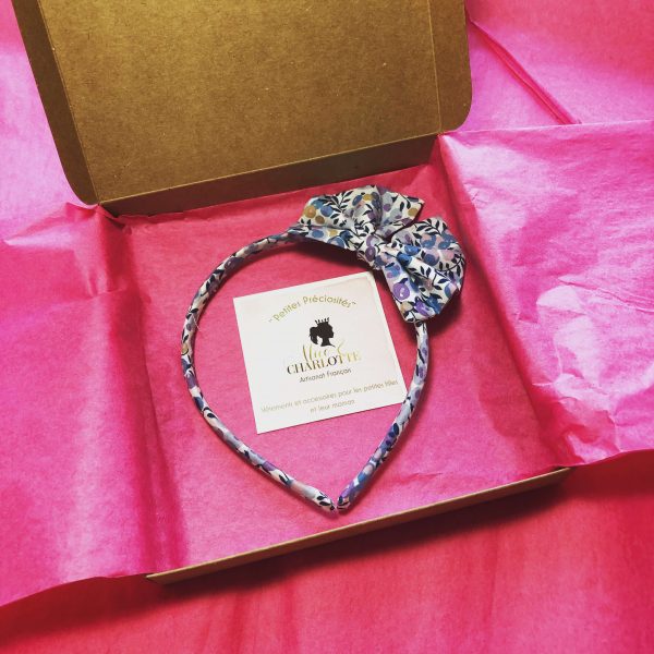 boîte cadeau kraft ouverte contenant un papier de soie rose et un serre-tête en liberty ainsi qu'une carte de visite alice et charlotte